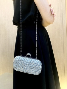 Close-up of sparkling silver rhinestone evening clutch with elegant wavy diamond patterns