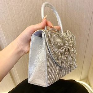 Sparkling silver evening handbag with crystal rhinestones and oversized bow decoration