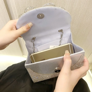 Sparkling silver rhinestone clutch bag with metal chain and magnetic snap for evening parties