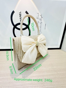 Detail of champagne glitter evening bag with large chiffon bow and rhinestone buckle