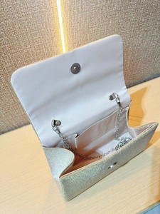 Sparkling champagne gold pleated evening clutch bag with silver chain strap for weddings