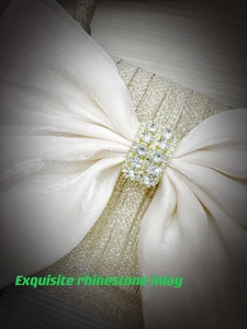 Close-up of elegant bow clutch featuring exquisite rhinestone inlay and glitter fabric