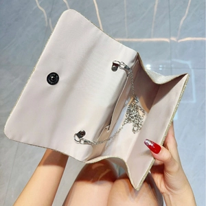 Sparkly champagne bow evening clutch bag with metallic chain strap for wedding party
