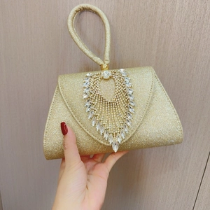 Detail of a sparkling gold evening clutch bag with radiant rhinestone embellishments
