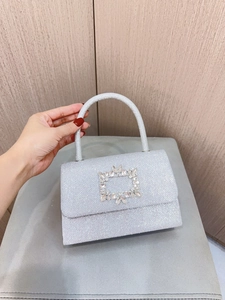 Detailed view of silver sequin evening clutch bag with a square rhinestone buckle clasp