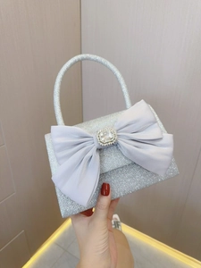 Detail showing the lavender satin bow and large square rhinestone on the silver sequin bag