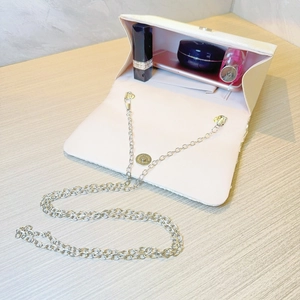 Interior view of pleated evening bag showing capacity for phone, lipstick and powder
