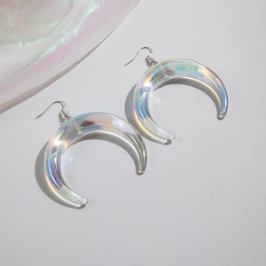 Close-up of iridescent resin crescent moon earrings with silver hooks and holographic finish