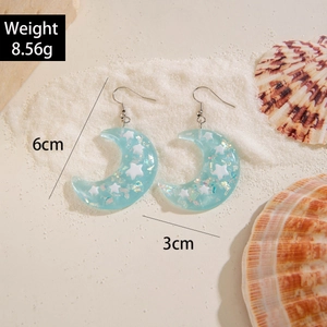 Blue resin crescent moon and star drop earrings with holographic glitter and silver hooks