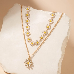 Double-layered gold flower pendant necklace with white and yellow daisy enamel charms