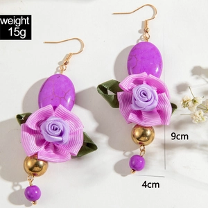 Detail view of handmade bohemian drop earrings with roses and turquoise beads size 9x4cm