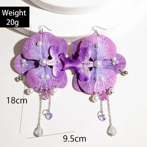 Detail view of purple orchid flower earrings with long tassels and pearls, 18cm length