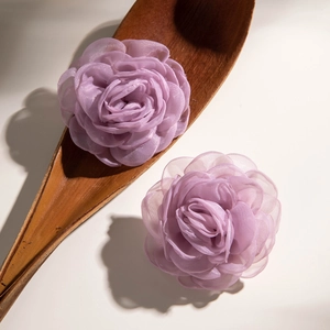 Macro detail of handmade lavender fabric rose petals with delicate layered silk texture