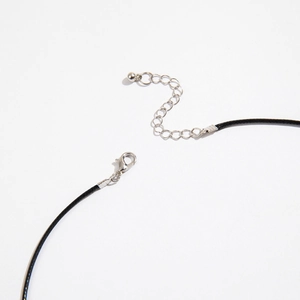 Detail of adjustable lobster clasp and silver extension chain on black cord necklace