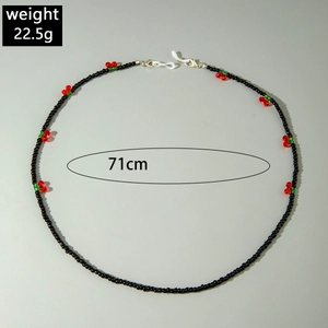 Detail of black beaded eyewear chain with cherry charms, 71cm long and weighing 22.5g