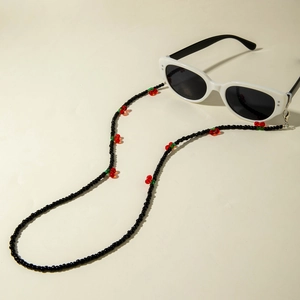 Fashionable black beaded eyewear chain with red and green cherry accents and non-slip loops