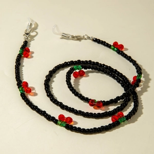 Detail of beaded glasses chain featuring handmade black beads and cherry accents