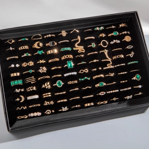 Bulk 100pcs gold alloy ring set with green gems and butterfly designs in a black box