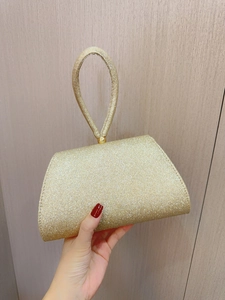 Elegant gold glitter evening clutch bag with circular handle for party and wedding outfits