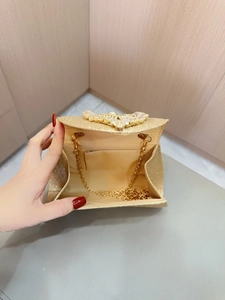 Elegant gold sequin evening clutch with heart rhinestone detail and interior chain strap