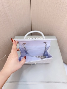 Silver sequin evening clutch bag with chain strap and geometric buckle shown open