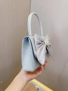 Elegant silver sequin handbag with grey satin bow and crystal centerpiece for parties