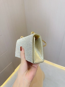 Sparkling gold evening clutch with rhinestones and circular metal top handles
