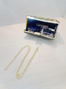 Macro view of crystal clutch interior capacity with chain strap and luxury gemstones