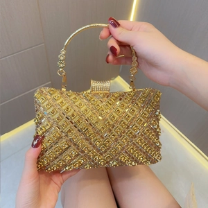 Macro detail of golden evening clutch bag featuring intricate crisscross rhinestone pattern