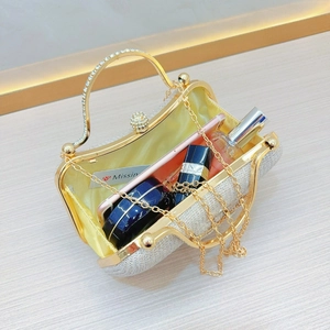 Detail of open silver sequin evening clutch with rhinestone handle and satin lining interior