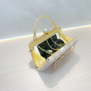 Detailed interior view of silver evening bag showing capacity for phone and cosmetics