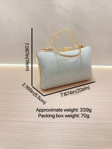 Silver glitter evening clutch with golden rhinestone handle and metal bow clasp