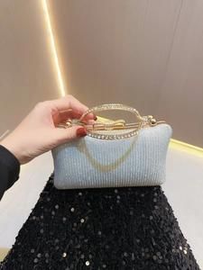 Elegant silver sequin evening clutch bag with gold rhinestone handle and bow clasp