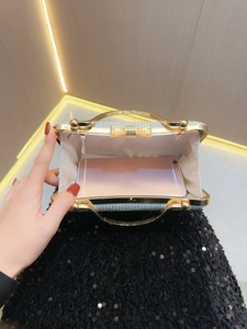 Close-up of silver sequin clutch showing spacious interior for a smartphone