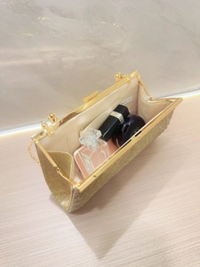 Elegant gold glitter evening clutch bag with open interior for phone and cosmetics