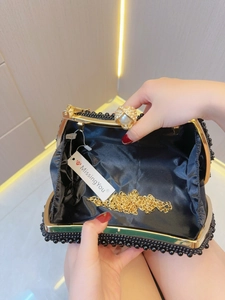 Elegant black beaded evening clutch with gold metal frame and pearl clasp closure