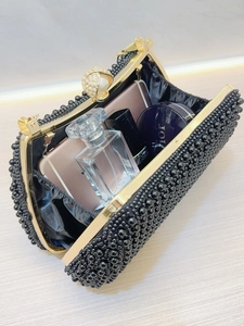 Luxurious black pearl beaded evening clutch bag with gold frame and rhinestone clasp