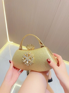 Elegant gold glitter evening clutch with crystal flower and crown clasp handle