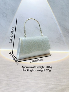 Silver rhinestone evening clutch with crystal wave flap and circular metal handle