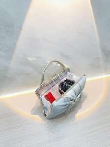 Silver pleated evening clutch bag with sparkling rhinestone bow and metal handle
