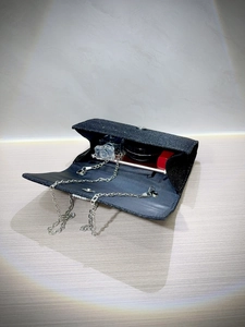 Elegant black glitter evening clutch with silver chain strap and interior storage space