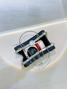 Internal view of black glitter evening bag showing space for phone and cosmetics
