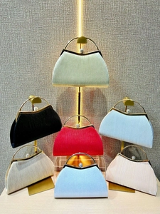 Collection of pleated evening clutch bags in seven vibrant colors with rhinestone clasps