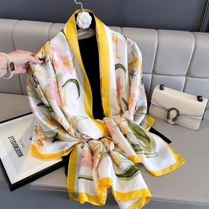 Floral print silk shawl in ivory with yellow borders hanging for beach sun protection