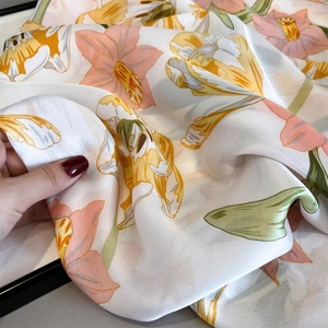 Close-up of floral silk scarf showing soft texture and premium draping effect