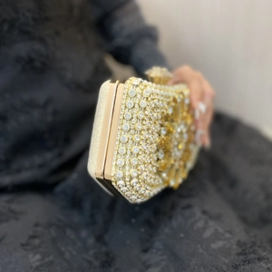 Elegant rhinestone clutch bag with crystal embellishments and golden metal frame for parties
