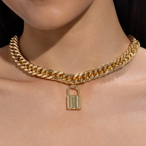 Close-up of a chunky gold Cuban chain necklace with a polished padlock pendant for women