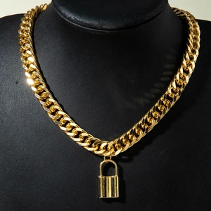 Close-up of golden Cuban link necklace with rectangular padlock pendant on black display