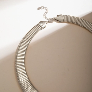 Detail showing smooth silver flat omega chain with secure lobster clasp and extender