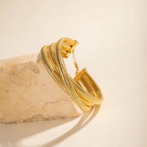 Detail of multi-layer golden snake chain collar with adjustable lobster clasp on marble